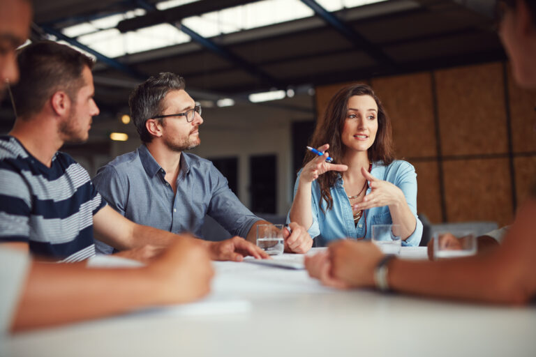 Sharing new ideas. Shot of a group of coworkers having a meeting in an open plan office